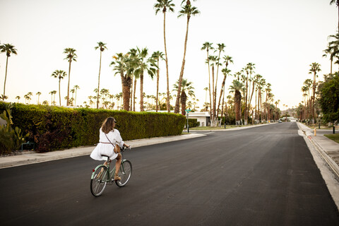 USA, California, Palm Springs, woman riding bicycle on the street stock photo