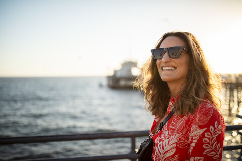 USA, California, Santa Monica, portrait of smiling woman at the waterfront stock photo