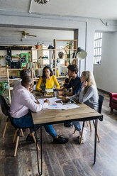 Business team having a meeting in loft office - GIOF05179