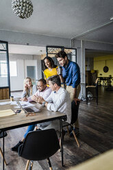 Confident business team having a meeting in loft office - GIOF05187