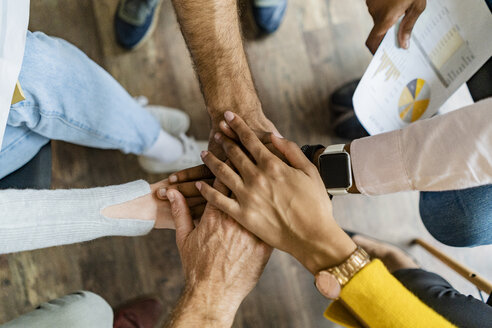 Close-up of business team stacking hands - GIOF05245