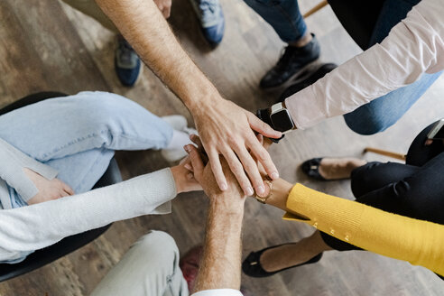 Close-up of business team stacking hands - GIOF05246