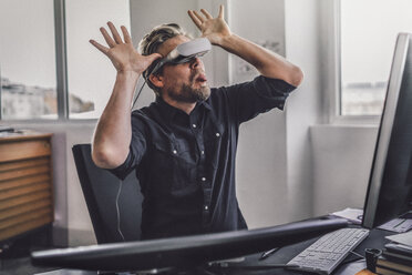 Graphic designer wearing VR glasses, sticking tongue out, mocking mischieviously - RIBF00818