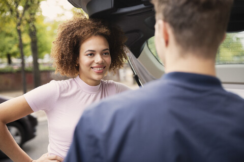 Young couple talking at car stock photo