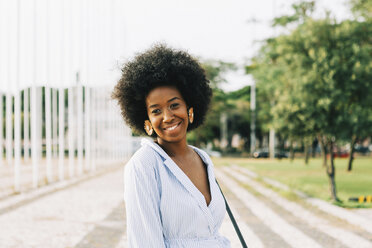 Portrait confident young woman in sunny park - FSIF03622