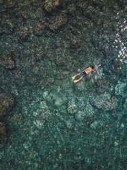 Indonesien, Bali, Mann schwimmt im Meer am Strand von Amed - KNTF02587