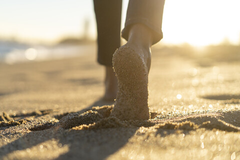 Bare feet of a woman, walking on the beach stock photo