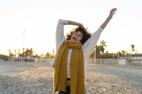 Happy woman having fun on the beach at sunset - AFVF02161