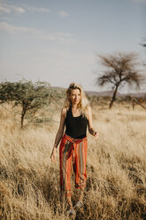 Afrika, Namibia, blonde Frau geht im Grasland spazieren - LHPF00227