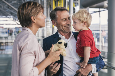 Happy businessman carrying son at the airport - MFF04758