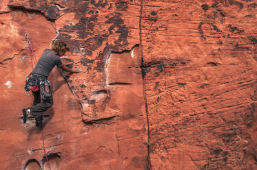 Man rock climbing on sandstone cliff, Red Rock Canyon National Conservation Area, Nevada, USA - AURF07940