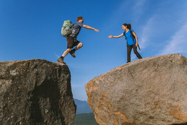 Mann springt über Felsen, Pitchoff Mountain, Adirondack Mountains, New York State, USA - AURF07955