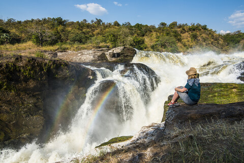 Africa, Uganda, Woman looks at the stunning Murchison Falls, on the Nile, Murchison Falls National Park stock photo