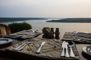 Africa, Uganda, Ready set table in a restaurant, above the Kazinga channel, Queen Elizabeth National Park - RUNF00512