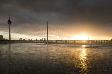 Germany, Duesseldorf, Oberkassel Bridge with Media Harbour in the background at twilight - SKAF00095