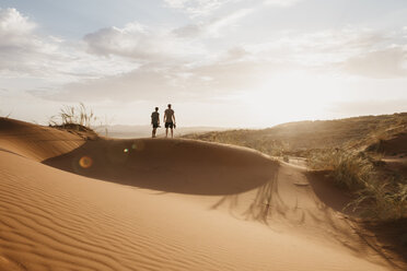 Namibia, Namib desert, Namib-Naukluft National Park, Sossusvlei, two men standing on Elim Dune at sunset - LHPF00255