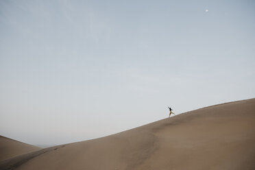 Namibia, Namib, woman running down desert dune - LHPF00280