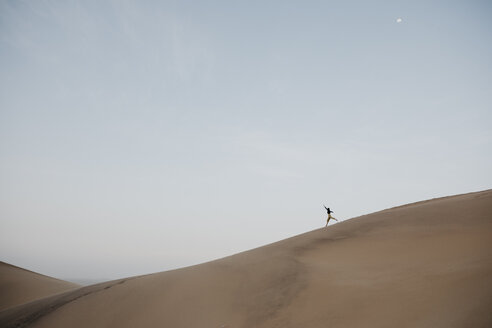 Namibia, Namib, woman running down desert dune - LHPF00280