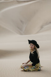 Namibia, Namib, portrait of fashionable woman sitting on desert dune - LHPF00282