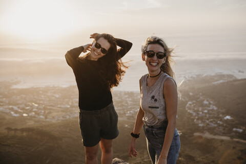 South Africa, Cape Town, Kloof Nek, portrait of two happy women at sunset stock photo