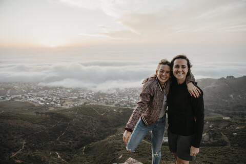 South Africa, Cape Town, Kloof Nek, portrait of two happy women embracing at sunset stock photo