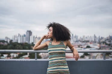 Panama, Panama-Stadt, nachdenkliche junge Frau auf Balkon mit Blick in die Ferne - KKAF03097