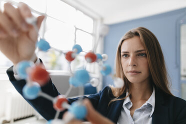 Female scientist studying molecule model - GUSF01679