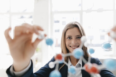 Female scientist studying molecule model - GUSF01681