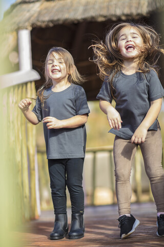 Two happy girls laughing and playing stock photo