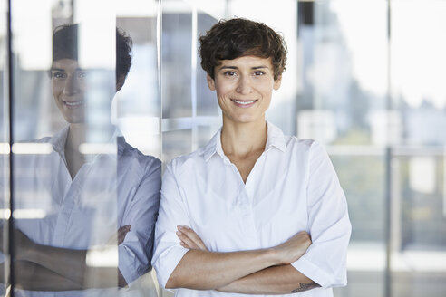 Portrait of smiling businesswoman in office - RBF06936