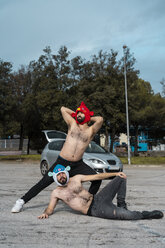 Schwules Paar mit Tierhüten posiert auf einem Parkplatz - AFVF02185