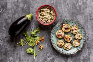 Baked aubergine slices spread with walnut creme garnished with pomegranate seeds - SARF04028