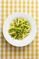 Penne with peas and pine nuts on plate, from above - GIOF05269