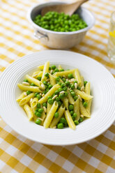 Penne with peas and pine nuts on plate - GIOF05270