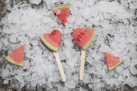 Wassermelonenherz-Eislutscher auf gecrashtem Eis, lizenzfreies Stockfoto