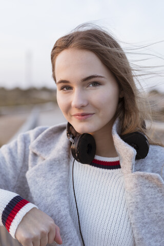 Portrait of smiling young woman at sunset stock photo