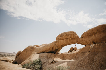 Namibia, Spitzkoppe, Mann steht auf Felsbrocken an Felsformation - LHPF00348