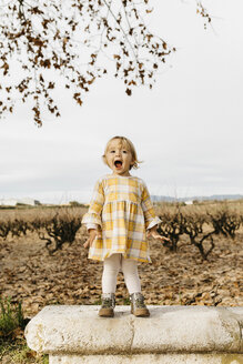 Little girl screaming on a park bench - JRFF02277