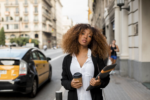 Young woman with laptop bag and coffee to go in the city, missing the taxi - MAUF02133