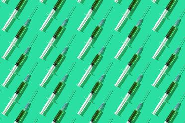 Multiple syringes organized in a pattern over green background - DRBF00123