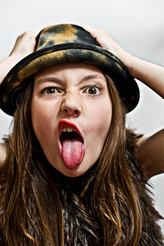 Portrait of girl sticking out tongue stock photo