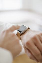 Man pointing at his smartwatch - KNSF05463