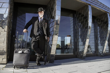 Elegant businessman with bowler hat, preparing for a business rip - RHF02436