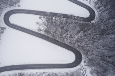 Austria, Wienerwald, winding road in snow-covered landscape, aerial view - HMEF00170