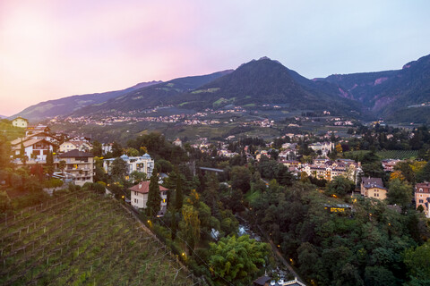 Italy, Alto Adige, Meran, cityscape at sunset stock photo