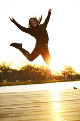 Woman jumping in joy - AURF08109