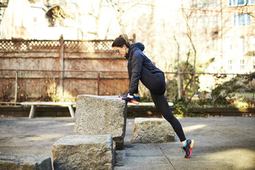 Female runner stretching in park - AURF08127