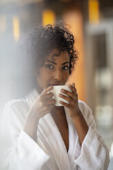 Portrait of young woman drinking coffee in spa - ZEF16099