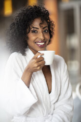 Portrait of smiling young woman drinking coffee in spa - ZEF16100