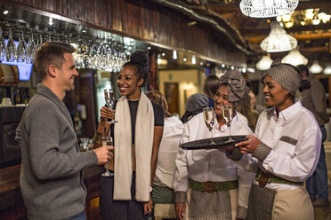 Couple having a glass of champagne in a bar - ZEF16122